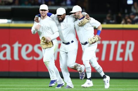 SEATTLE, WASHINGTON – AUGUST 24: From left to right, Billy McKinney #28, Teoscar Hernandez #37 and Randal Grichuk #15 of the Toronto Blue Jays celebrate their 7-5 win against the Seattle Mariners during their game at T-Mobile Park on August 24, 2019 in Seattle, Washington. Teams are wearing special color schemed uniforms with players choosing nicknames to display for Players’ Weekend. (Photo by Abbie Parr/Getty Images)