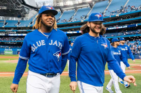 TORONTO, ONTARIO – SEPTEMBER 29: Vladimir Guerrero Jr. #27 and Bo Bichette #11 of the Toronto Blue Jays walk off the field after defeating the Tampa Bay Rays in the last game of the season in their MLB game at the Rogers Centre on September 29, 2019 in Toronto, Canada. (Photo by Mark Blinch/Getty Images)