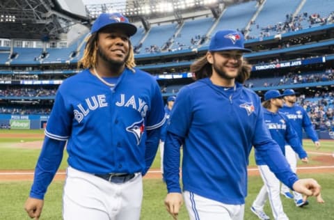 TORONTO, ONTARIO – SEPTEMBER 29: Vladimir Guerrero Jr. #27 and Bo Bichette #11 of the Toronto Blue Jays walk off the field after defeating the Tampa Bay Rays in the last game of the season in their MLB game at the Rogers Centre on September 29, 2019 in Toronto, Canada. (Photo by Mark Blinch/Getty Images)