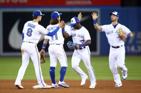 TORONTO, ON – SEPTEMBER 10: Cavan Biggio #8, Bo Bichette #11, Jonathan Davis #49 and Randal Grichuk #15 of the Toronto Blue Jays celebrate the win following the ninth inning of a MLB game against the Boston Red Sox at Rogers Centre on September 10, 2019 in Toronto, Canada. (Photo by Vaughn Ridley/Getty Images)