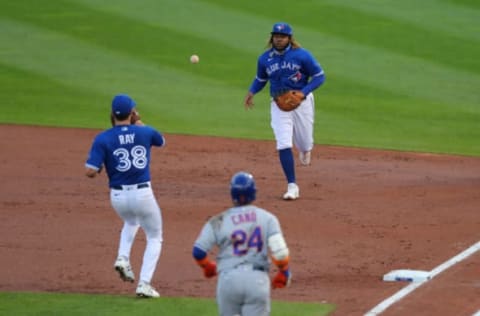 BUFFALO, NY – SEPTEMBER 12: Vladimir Guerrero Jr. #27 of the Toronto Blue Jays makes the throw to Robbie Ray #38 to get Robinson Cano #24 of the New York Mets out at first base during the second inning at Sahlen Field on September 12, 2020 in Buffalo, New York. (Photo by Timothy T Ludwig/Getty Images)