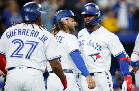 TORONTO, ON – APRIL 08: Teoscar Hernandez #37 of the Toronto Blue Jays celebrates a three run home run with Vladimir Guerrero Jr. #27, and Bo Bichette #11 in the fifth inning of their MLB game against the Texas Rangers on Opening Day at Rogers Centre on April 8, 2022 in Toronto, Canada. (Photo by Cole Burston/Getty Images)