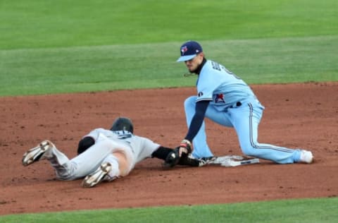 BUFFALO, NEW YORK – AUGUST 11: Jonathan Villar #2 of the Miami Marlins slides back to second base on a pick-off attempt as Cavan Biggio #8 of the Toronto Blue Jays tags him during the third inning at Sahlen Field on August 11, 2020 in Buffalo, New York. Villar was called safe. The Blue Jays are the home team due to their stadium situation and the Canadian government’s policy on COVID-19. (Photo by Bryan M. Bennett/Getty Images)