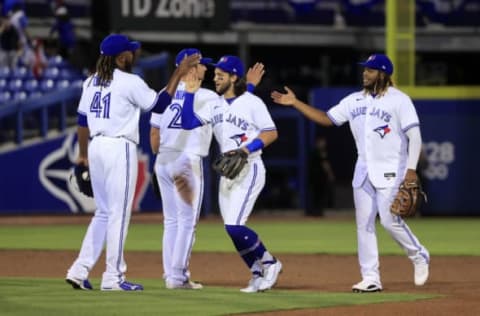 DUNEDIN, FLORIDA – APRIL 27: Rafael Dolis #41, Joe Panik #2, Bo Bichette #11, and Vladimir Guerrero Jr. #27 of the Toronto Blue Jays celebrate a win against the Washington Nationals at TD Ballpark on April 27, 2021 in Dunedin, Florida. The Blue Jays won the game 9-5. (Photo by Sam Greenwood/Getty Images)