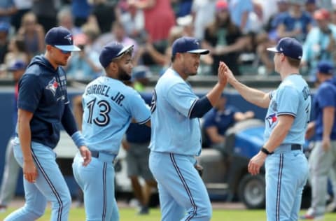 BUFFALO, NEW YORK – JULY 18: Toronto Blue Jays teammates slap hands with Hyun Jin Ryu #99 of the Toronto Blue Jays after defeating the Texas Rangers 5-0 in game one of a doubleheader at Sahlen Field on July 18, 2021 in Buffalo, New York. (Photo by Bryan M. Bennett/Getty Images)