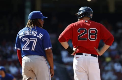 BOSTON, MA – JULY 28: Vladimir Guerrero Jr. #27 of the Toronto Blue Jays talks with J.D. Martinez #28 of the Boston Red Sox during first game of a doubleheader at Fenway Park on July 28, 2021 in Boston, Massachusetts. (Photo By Winslow Townson/Getty Images)