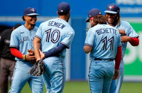 TORONTO, ON – JULY 31: Santiago Espinal #5 of the Toronto Blue Jays and Vladimir Guerrero Jr. #27 laugh with teammates Marcus Semien #10 and Bo Bichette #11 during their MLB game against the Kansas City Royals at Rogers Centre on July 31, 2021 in Toronto, Ontario. (Photo by Cole Burston/Getty Images)