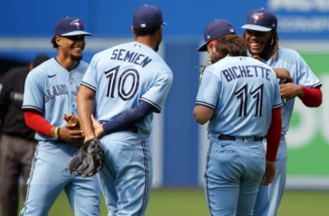 TORONTO, ON – JULY 31: Santiago Espinal #5 of the Toronto Blue Jays and Vladimir Guerrero Jr. #27 laugh with teammates Marcus Semien #10 and Bo Bichette #11 during their MLB game against the Kansas City Royals at Rogers Centre on July 31, 2021 in Toronto, Ontario. (Photo by Cole Burston/Getty Images)