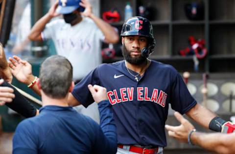 ARLINGTON, TEXAS – OCTOBER 03: Amed Rosario #1 of the Cleveland Indians is greeted by teammates after scoring in the third inning against the Texas Rangers at Globe Life Field on October 03, 2021 in Arlington, Texas. (Photo by Tim Warner/Getty Images)