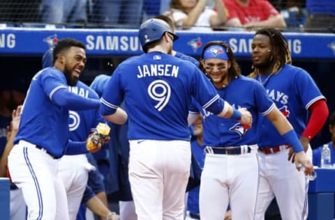 TORONTO, ON – OCTOBER 02: Danny Jansen #9 of the Toronto Blue Jays celebrates with Teoscar Hernandez #37, Alek Manoah #6, Bo Bichette #11 and Vladimir Guerrero Jr. #27 after hitting a 2-run home run in the fifth inning during a MLB game against the Baltimore Orioles at Rogers Centre on October 2, 2021 in Toronto, Ontario, Canada. (Photo by Vaughn Ridley/Getty Images)