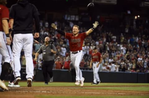 PHOENIX, ARIZONA – OCTOBER 03: Josh VanMeter #19 of the Arizona Diamondbacks celebrates with teammates after hitting a walk-off home run against the Colorado Rockies during the ninth inning at Chase Field on October 03, 2021 in Phoenix, Arizona. Diamondbacks won 5-4. (Photo by Norm Hall/Getty Images)