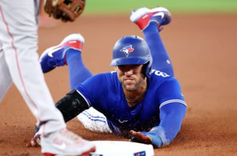 TORONTO, ON – SEPTEMBER 30: George Springer #4 of the Toronto Blue Jays is safe at third on a passed ball by Reese McGuire #3 of the Boston Red Sox in the first inning at Rogers Centre on September 30, 2022 in Toronto, Ontario, Canada. (Photo by Vaughn Ridley/Getty Images)