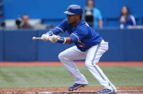 TORONTO, CANADA – AUGUST 12: Emilio Bonifacio #1 of the Toronto Blue Jays tries to lay down a bunt during MLB game action against the Oakland Athletics on August 12, 2013 at Rogers Centre in Toronto, Ontario, Canada. (Photo by Tom Szczerbowski/Getty Images)