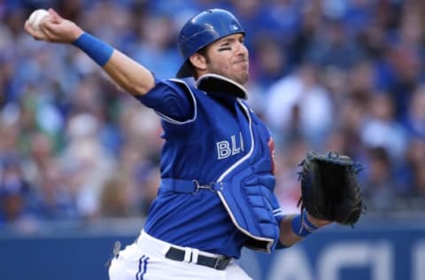 TORONTO, CANADA – SEPTEMBER 14: J.P. Arencibia #9 of the Toronto Blue Jays throws out the baserunner in the fourth inning during MLB game action against the Baltimore Orioles on September 14, 2013 at Rogers Centre in Toronto, Ontario, Canada. (Photo by Tom Szczerbowski/Getty Images)