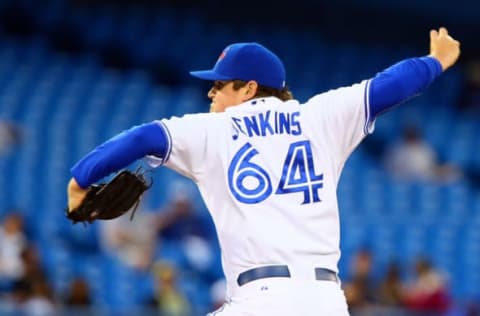 TORONTO, ON – JUNE 10: Chad Jenkins #64 of the Toronto Blue Jays throws a pitch in the 7th inning against the Minnesota Twins during MLB action at the Rogers Centre June 10, 2014 in Toronto, Ontario, Canada. (Photo by Abelimages/Getty Images)