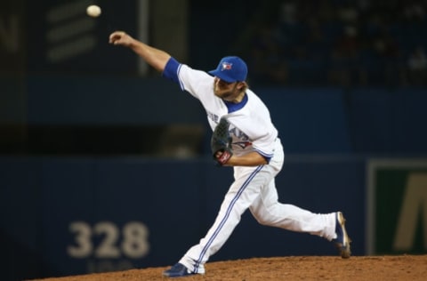 TORONTO, CANADA – AUGUST 22: Kyle Drabek #4 of the Toronto Blue Jays delivers a pitch in the seventh inning during MLB game action against the Tampa Bay Rays on August 22, 2014 at Rogers Centre in Toronto, Ontario, Canada. (Photo by Tom Szczerbowski/Getty Images)