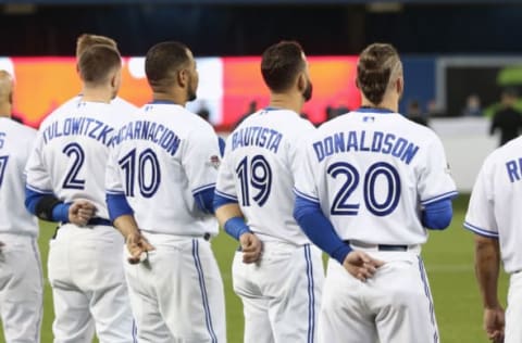 TORONTO, CANADA – OCTOBER 8: Troy Tulowitzki #2 of the Toronto Blue Jays and Edwin Encarnacion #10 and Jose Bautista #19 and Josh Donaldson #20 stand for the playing of the Canadian anthem during lineup introductions before the start of action against the Texas Rangers in Game One of the American League Division Series during the 2015 MLB Playoffs at Rogers Centre on October 8, 2015 in Toronto, Ontario, Canada. (Photo by Tom Szczerbowski/Getty Images)