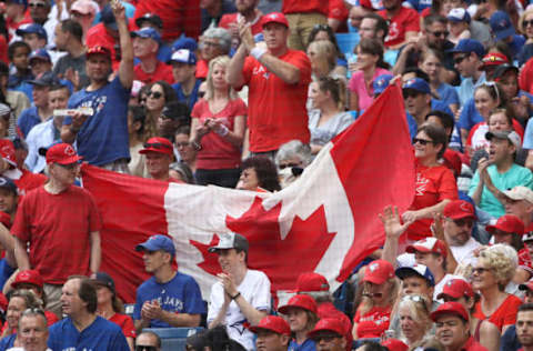 TORONTO, ON – JULY 1: Toronto Blue Jays fans unfurl a Canadian flag on Canada Day during MLB game action against the Boston Red Sox at Rogers Centre on July 1, 2017 in Toronto, Canada. (Photo by Tom Szczerbowski/Getty Images)