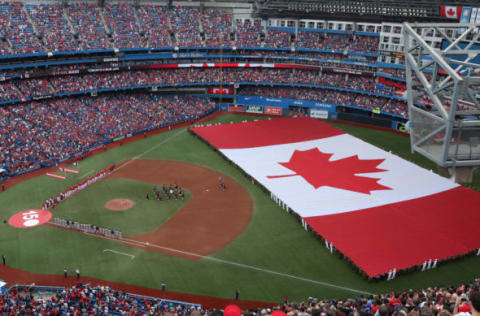 TORONTO, ON – JULY 1: A general view of Rogers Centre as a large Canadian flag is unfurled in the outfield on Canada Day during the playing of the Canadian national anthem before the start of the Toronto Blue Jays MLB game against the Boston Red Sox at Rogers Centre on July 1, 2017 in Toronto, Canada. (Photo by Tom Szczerbowski/Getty Images)