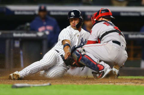 NEW YORK, NY – MAY 08: Gleyber Torres #25 of the New York Yankees is tagged out by Christian Vazquez #7 of the Boston Red Sox trying to score on Aaron Judge #99 single in the seventh inning at Yankee Stadium on May 8, 2018 in the Bronx borough of New York City. (Photo by Mike Stobe/Getty Images)