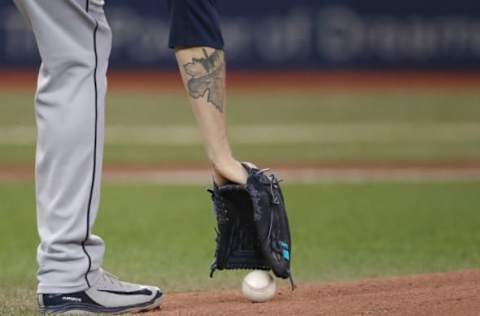 TORONTO, ON – MAY 8: James Paxton #65 of the Seattle Mariners picks up the baseball off the turf before beginning to pitch the second inning with his maple leaf tattoo on his right forearm during MLB game action against the Toronto Blue Jays at Rogers Centre on May 8, 2018 in Toronto, Canada. (Photo by Tom Szczerbowski/Getty Images) *** Local Caption *** James Paxton