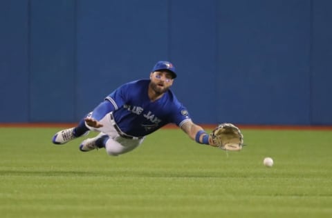 TORONTO, ON – MAY 18: Kevin Pillar #11 of the Toronto Blue Jays dives but cannot catch a bloop double hit by Jed Lowrie #8 of the Oakland Athletics in the sixth inning during MLB game action at Rogers Centre on May 18, 2018 in Toronto, Canada. (Photo by Tom Szczerbowski/Getty Images)