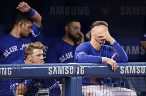 TORONTO, ON – MAY 18: Justin Smoak #14 of the Toronto Blue Jays and Josh Donaldson #20 and Luke Maile #21 (Back Left) and Kevin Pillar #11 (Back Right) look on with two outs in the bottom of the ninth inning during MLB game action against the Oakland Athletics at Rogers Centre on May 18, 2018 in Toronto, Canada. (Photo by Tom Szczerbowski/Getty Images)