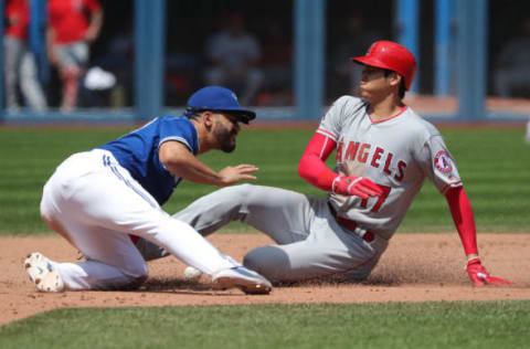 TORONTO, ON – MAY 24: Shohei Ohtani #17 of the Los Angeles Angels of Anaheim arrives safely at second base in the eighth inning during MLB game action as Devon Travis #29 of the Toronto Blue Jays cannot handle the throw at Rogers Centre on May 24, 2018 in Toronto, Canada. (Photo by Tom Szczerbowski/Getty Images)