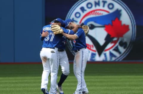 TORONTO, ON – JUNE 10: Teoscar Hernandez #37 of the Toronto Blue Jays and Randal Grichuk #15 and Kevin Pillar #11 celebrate their sweep during MLB game action against the Baltimore Orioles at Rogers Centre on June 10, 2018 in Toronto, Canada. (Photo by Tom Szczerbowski/Getty Images)