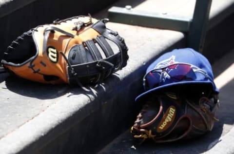 ARLINGTON, TX – MAY 18: Toronto Blue Jays’ players Wilson baseball gloves lay in the dugout during a baseball game against the Texas Rangers at Globe Life Park on May 18, 2014 in Arlington, Texas. Texas won 6-2. (Photo by Brandon Wade/Getty Images)