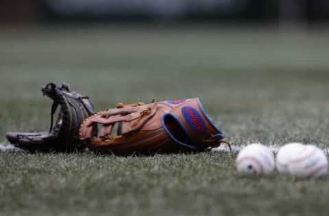 CHICAGO, IL – APRIL 13: Gloves and balls are seen on the field before the Chicago Cubs take on the Atlanta Braves at Wrigley Field on April 13, 2018 in Chicago, Illinois. The Braves defeated the Cubs 4-0. (Photo by Jonathan Daniel/Getty Images)