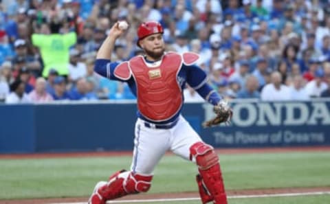 TORONTO, ON – JULY 4: Russell Martin #55 of the Toronto Blue Jays fields a soft grounder in front of home plate and throws out the baserunner in the third inning during MLB game action against the New York Mets at Rogers Centre on July 4, 2018 in Toronto, Canada. (Photo by Tom Szczerbowski/Getty Images)