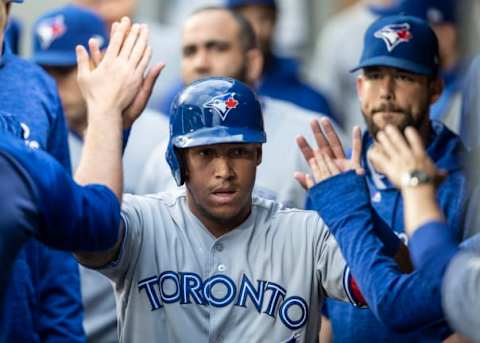 SEATTLE, WA – AUGUST 2: Yangervis Solarte #26 of the Toronto Blue Jays is congratulated by teammates in the dugout after scoring on a two-run single by Devon Travis #29 of the Toronto Blue Jays off of starting pitcher Felix Hernandez #34 of the Seattle Mariners that also scored Teoscar Hernandez #37 of the Toronto Blue Jays during the second inning of a game at Safeco Field on August 2, 2018 in Seattle, Washington. (Photo by Stephen Brashear/Getty Images)