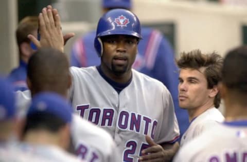 Toronto Blue Jays Carlos Delgado is congratulated by his teammates in the dougout after scoring on a Tony Batista sacrifice fly to left field during the fourth inning against the Detroit Tigers in Detroit, Michigan, 26 May 2000. (Electronic Image) AFP Photo/Jeff KOWALSKY (Photo by JEFF KOWALSKY / AFP) (Photo credit should read JEFF KOWALSKY/AFP via Getty Images)