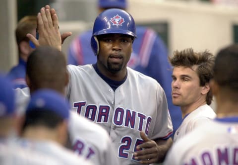 Toronto Blue Jays Carlos Delgado is congratulated by his teammates in the dougout after scoring on a Tony Batista sacrifice fly to left field during the fourth inning against the Detroit Tigers in Detroit, Michigan, 26 May 2000. (Electronic Image) AFP Photo/Jeff KOWALSKY (Photo by JEFF KOWALSKY / AFP) (Photo credit should read JEFF KOWALSKY/AFP via Getty Images)