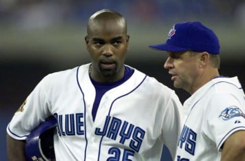 Toronto Blue Jays’ first baseman Carlos Delgado(L) talks with first base coach Garth Iorg during the last inning of the game vs. Seattle Mariners in Toronto, Canada, 11 May, 2001. Seattle won the game 7:2. AFP PHOTO/ ZORAN BOZICEVIC (Photo by ZORAN BOZICEVIC / AFP) (Photo by ZORAN BOZICEVIC/AFP via Getty Images)