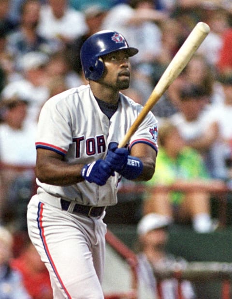 Carlos Delgado of the Toronto Blue Jays hits a solo home run in the second inning against the Texas Rangers at the Ballpark in Arlington, TX, on 06 August 1999. Delgado added a second solo homer in the seventh and a third in the eighth. AFP PHOTO PAUL BUCK (Photo by PAUL BUCK / AFP) (Photo by PAUL BUCK/AFP via Getty Images)