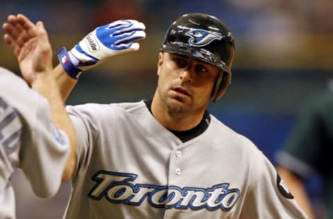 Toronto center fielder Reed Johnson gets a high five from third base coach Brian Butterfield after his first inning home run against Tampa Bay at Tropicana Field in St. Petersburg, Florida on June 2, 2006. (Photo by J. Meric/Getty Images)