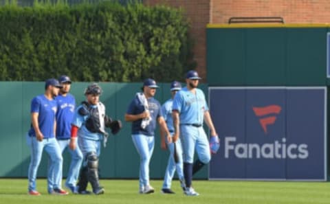 DETROIT, MI – AUGUST 28: Toronto Blue Jays players and coaches walk in from the bullpen in front of a Fanatics sign on the outfield wall prior to the game against the Detroit Tigers at Comerica Park on August 28, 2021 in Detroit, Michigan. Earlier in the month Major League Baseball and the Major League Baseball Players Association (MLBPA) announced an agreement to a new licensing deal with Fanatics to produce baseball cards ending a longtime agreement with Topps. Topps agreements with the MLB and the MLBPA run through 2025 and 2022, respectively. The Blue Jays defeated the Tigers 3-2. (Photo by Mark Cunningham/MLB Photos via Getty Images)