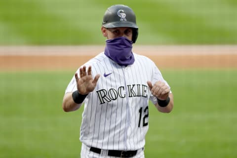 DENVER, COLORADO – AUGUST 01: Chris Owings #12 of the Colorado Rockies celebrates at a distance in the second inning after scoring on a error on a pick off throw to first base by Joey Lucchesi of the San Diego Padres at Coors Field on August 01, 2020 in Denver, Colorado. (Photo by Matthew Stockman/Getty Images)