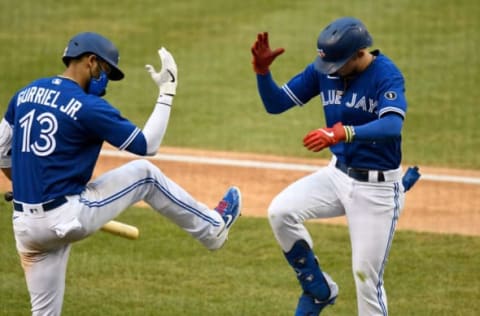 WASHINGTON, DC – JULY 30: Cavan Biggio #8 of the Toronto Blue Jays celebrates with Lourdes Gurriel Jr. #13 after hitting a home run in the seventh inning against the Washington Nationals at Nationals Park on July 30, 2020 in Washington, DC, United States. The Blue Jays played as the home team due to their stadium situation and the Canadian governmentÕs policy on COVID-19. (Photo by G Fiume/Getty Images)