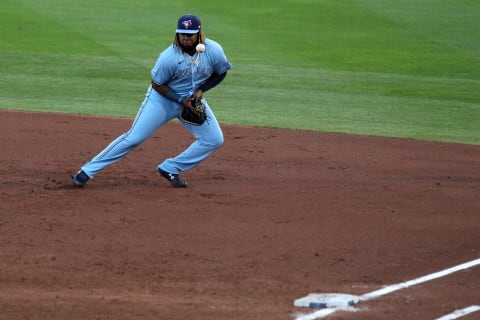 BUFFALO, NEW YORK – AUGUST 12: Vladimir Guerrero Jr. #27 of the Toronto Blue Jays attempts to field a ground ball during the third inning of an MLB game against the Miami Marlins at Sahlen Field on August 12, 2020 in Buffalo, New York. The Blue Jays are the home team and are playing their home games in Buffalo due to the Canadian government’s policy on COVID-19. (Photo by Bryan M. Bennett/Getty Images)