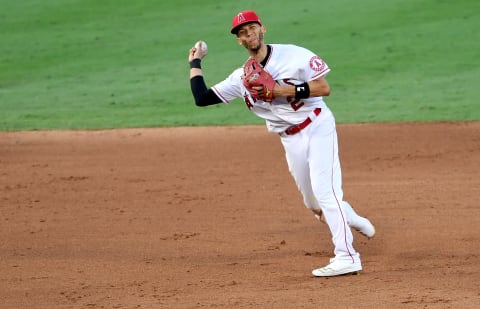 ANAHEIM, CA – SEPTEMBER 03: Andrelton Simmons #2 of the Los Angeles Angels slips on the infield as he throws out Fernando Tatis Jr. #23 of the San Diego Padres at first base in the ninth inning of the game at Angel Stadium of Anaheim on September 3, 2020 in Anaheim, California. (Photo by Jayne Kamin-Oncea/Getty Images)