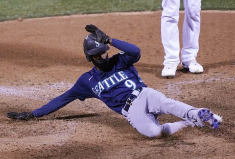 OAKLAND, CALIFORNIA – SEPTEMBER 25: Dee Strange-Gordon #9 of the Seattle Mariners scores on a passed ball against the Oakland Athletics in the top of the 10th inning at RingCentral Coliseum on September 25, 2020 in Oakland, California. (Photo by Thearon W. Henderson/Getty Images)