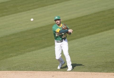 OAKLAND, CALIFORNIA – SEPTEMBER 30: Tommy La Stella #3 of the Oakland Athletics throws to first base throwing out Jose Abreu #79 of the Chicago White Sox to end Game Two of the American League Wild Card Round at RingCentral Coliseum on September 30, 2020 in Oakland, California. The Athletics won the game 5-3.(Photo by Thearon W. Henderson/Getty Images)