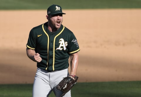 LOS ANGELES, CALIFORNIA – OCTOBER 07: Liam Hendriks #16 of the Oakland Athletics celebrates a 9-7 win against the Houston Astros in Game Three of the American League Division Series at Dodger Stadium on October 07, 2020 in Los Angeles, California. (Photo by Kevork Djansezian/Getty Images)