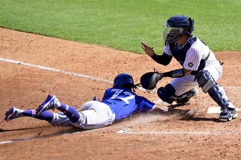 TAMPA, FLORIDA – FEBRUARY 28: Otto Lopez #72 of the Toronto Blue Jays slides safely into home plate under the glove of Robinson Chirinos #61 of the New York Yankees on an rbi single from Lourdes Gurriel Jr. #13 during the fourth inning during a spring training game at George M. Steinbrenner Field on February 28, 2021, in Tampa, Florida. (Photo by Douglas P. DeFelice/Getty Images)