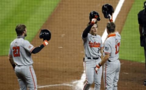 HOUSTON, TEXAS – MARCH 05: Anthony McKenzie #2 of Sam Houston St. is congratulated by Colton Cowser #17 and Corbin Vines #27 after hitting a home run against the Rice Owls at Minute Maid Park on March 05, 2021 in Houston, Texas. (Photo by Bob Levey/Getty Images)