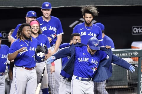 BALTIMORE, MARYLAND – SEPTEMBER 11: Teoscar Hernandez #37 of the Toronto Blue Jays puts the home run jacket on George Springer #4 after Springer’s two-run home run in the seventh inning against the Baltimore Orioles during game one of a doubleheader at Oriole Park at Camden Yards on September 11, 2021 in Baltimore, Maryland. (Photo by Greg Fiume/Getty Images)