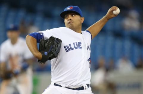 TORONTO, CANADA – SEPTEMBER 10: Ricky Romero #24 of the Toronto Blue Jays delivers a pitch in the seventh inning during MLB game action against the Los Angeles Angels of Anaheim on September 10, 2013 at Rogers Centre in Toronto, Ontario, Canada. (Photo by Tom Szczerbowski/Getty Images)